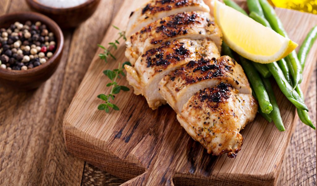 Grilled chicken on a cutting board Grilled chicken on a cutting board with thyme and green beans